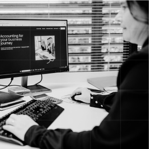 Professional reviewing business compliance and advisory website, representing employment contract and non-compete clause updates