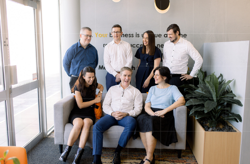 The staff of Trekk Advisory poses at the lounge of Brisbane office.ne