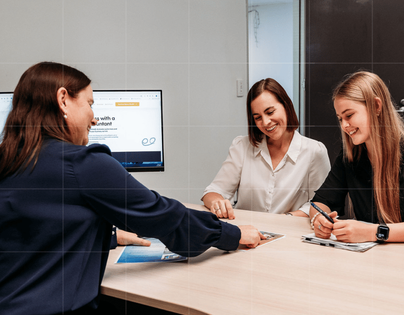 Business advisory session reviewing financial documents and growth opportunities.