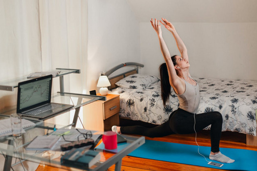 A businesswoman is doing yoga to stay focused and reduce anxiety.