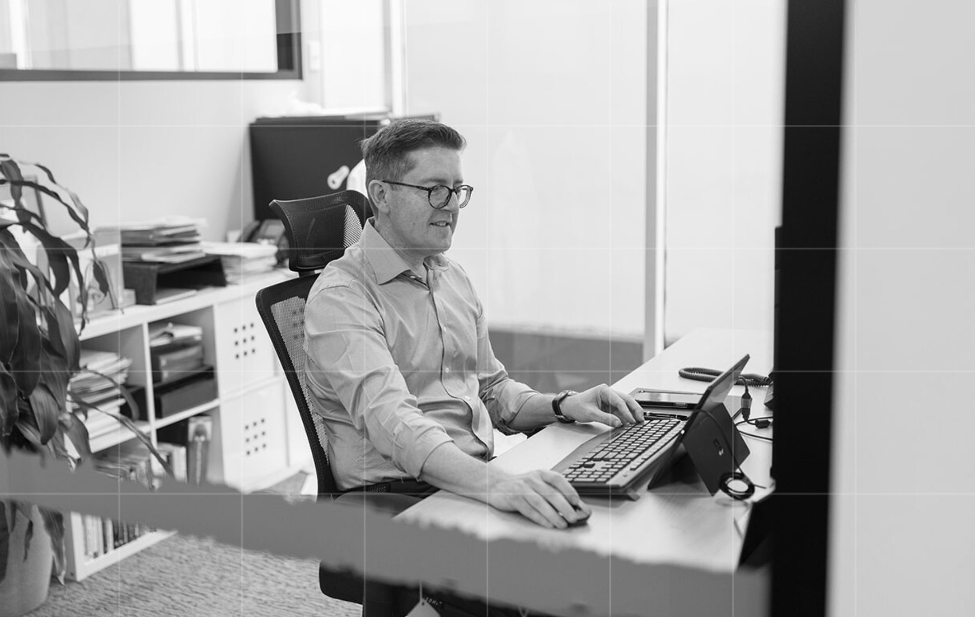 Tax consultant working on financial reports at a desk in the Trekk Advisory office, showcasing attention to detail in business advisory services.