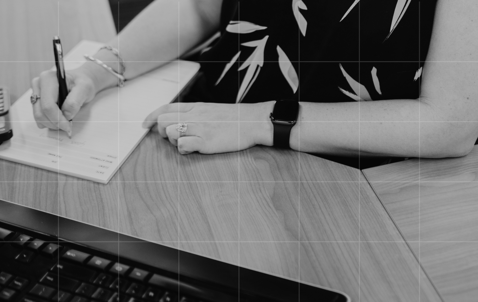 Advisor taking notes during business advisory planning and client consultation.