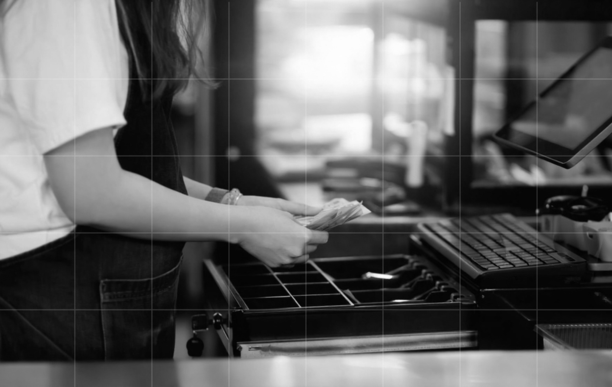 Retail employee handling cash at a checkout, showing how businesses may need to prepare for the cash comeback and new payment rules.